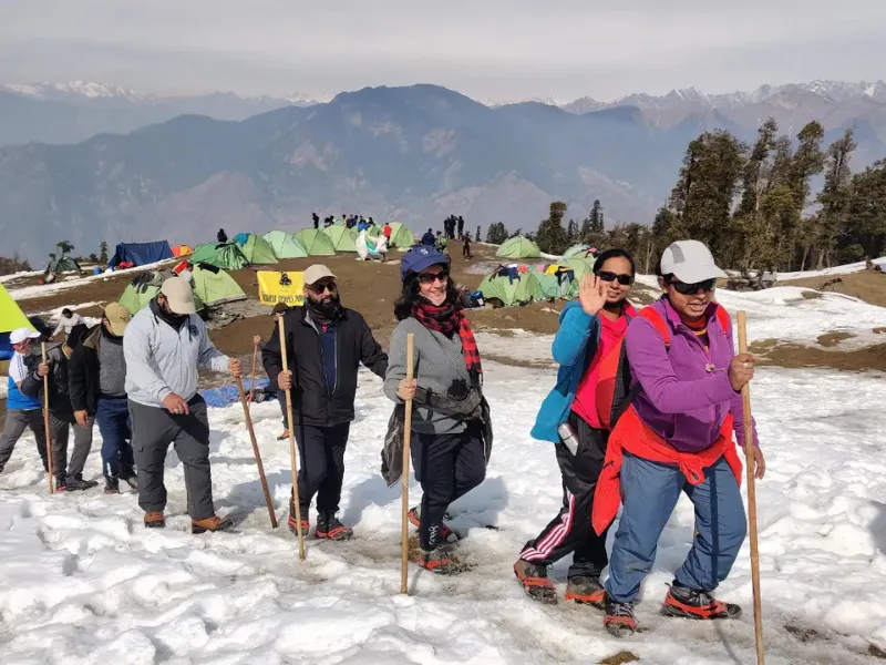a woman scubas in the ocean with a camera
